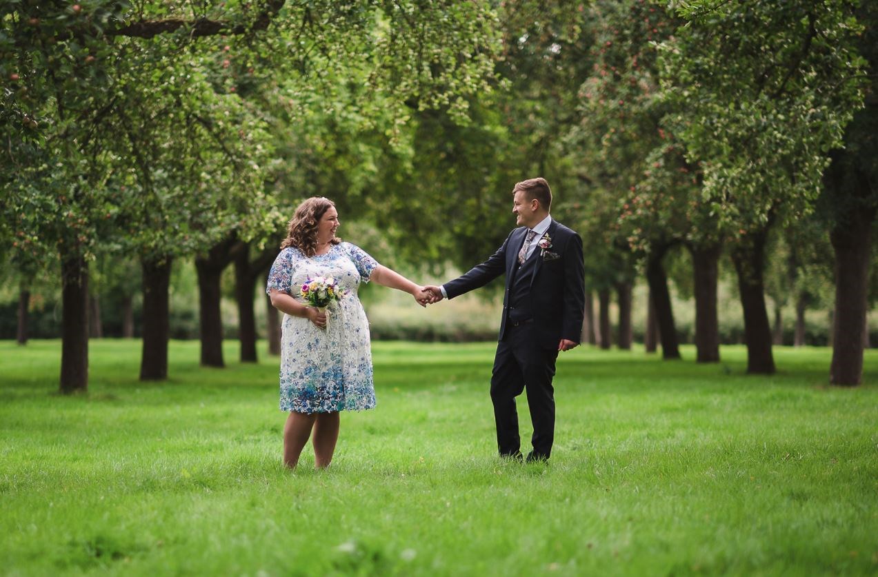 wedding-in-trees-holding-hands